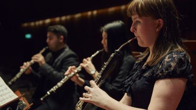 Students on stage playing wind instruments